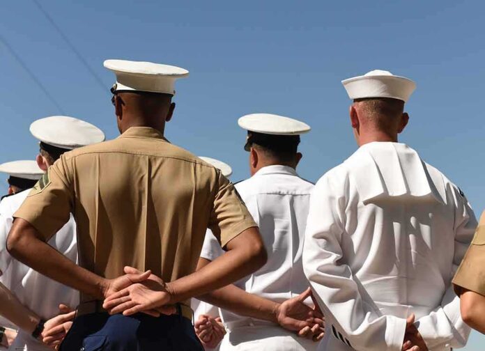 shutterstock_1210061623 sailors and marines standing in formation with hands behind backs