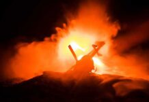 L.A. Crash Sparks Federal Scrutiny Toy helicopter silhouette against fiery explosion at night