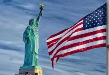 Blue-to-Red Shock Roils Governor Race Statue of Liberty beside a waving American flag
