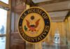 House OKs Sweeping DOJ Data Access U.S. House of Representatives seal on a glass door