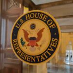 House OKs Sweeping DOJ Data Access U.S. House of Representatives seal on a glass door
