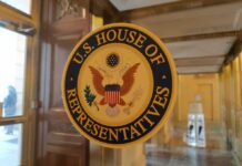 House OKs Sweeping DOJ Data Access U.S. House of Representatives seal on a glass door