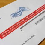 Supreme Court Keeps USPS Ballot Rule Blocked Mail-in ballot envelope with red label on wooden table