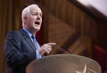 Civil War Brewing Inside GOP Elderly man in suit speaking at a podium