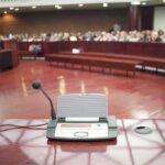 Fauci’s Fate Moves To Justice Conference microphone on a podium in a courtroom