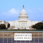Staff Affairs Claim Triggers Probe View of the U.S. Capitol building with a security barrier in front