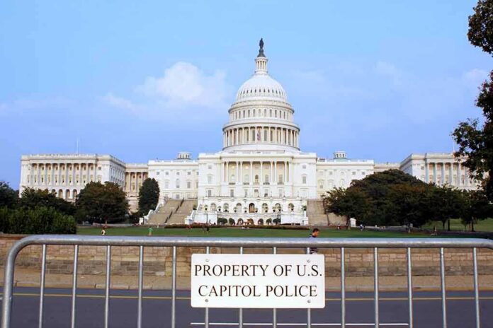 shutterstock_1913280-1 View of the U.S. Capitol building with a security barrier in front