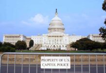 Lawmakers Face New Pressure Over Stocks View of the U.S. Capitol building with a security barrier in front