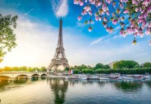 Paris Icon Shuts Over Women Ban Uproar Eiffel Tower by the Seine with boats and spring blossoms