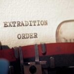 Typewriter typing extradition order on paper