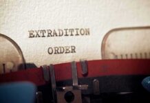 Typewriter typing extradition order on paper