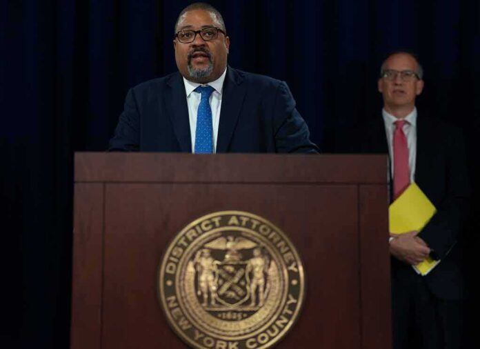 shutterstock_2199567225 Man speaks at podium with New York County District Attorney seal