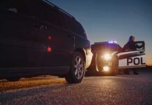 Mega Millions? Mega Mugshots Keep Coming Police officer at patrol car during traffic stop at dusk