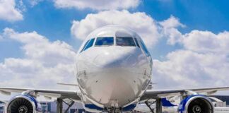 Commercial airplane on runway, front view