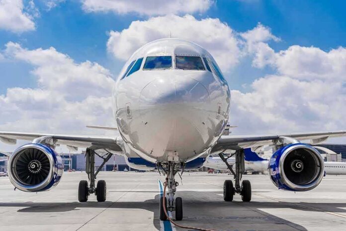 shutterstock_2341859701 Commercial airplane on runway, front view