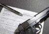 New Gun Gatekeepers Arrive in 2027 Handgun on firearm transaction form with pen