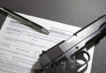 New Gun Gatekeepers Arrive in 2027 Handgun on firearm transaction form with pen