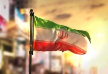 Silent Spills Threaten Iran’s Breadbasket Iranian flag waving on a pole at sunset