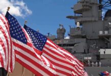 U.S. Veto Over Arctic Rivals? American flags in front of a naval ship under a blue sky
