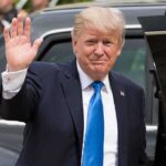 Trump Slams Brakes: 50% Tariffs Paused Donald Trump waves while standing beside a black vehicle