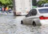 Bangkok Sinks: Entire City Declared Disaster Silver car partially submerged in floodwater