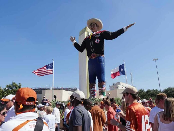 shutterstock_744408097 Giant cowboy statue towers over a crowd at an outdoor event