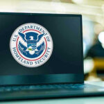 Election-Eve Raid Shocks Capitol Laptop displaying U.S. Department of Homeland Security logo.
