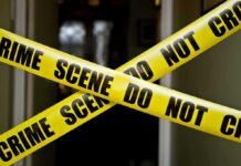 Campus ‘Coke’ Trap Ends In Tragedy Yellow crime scene tape crossing a doorway