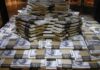 Epstein Money Clouds Crucial Senate Vote Stacks of U.S. hundred-dollar bills arranged in a pyramid