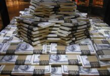Epstein Money Clouds Crucial Senate Vote Stacks of U.S. hundred-dollar bills arranged in a pyramid