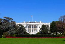 Pageant Night Allegation Shocks Washington The White House facade with flag and gardens