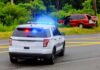 Capital Murder Shock In Texas Police SUV with flashing lights at roadside crash scene
