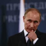 Vladimir Putin at a podium during a press event