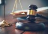 Judge's gavel on block with scales of justice