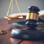 Judge's gavel on block with scales of justice