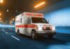Ambulance driving through a tunnel with emergency lights on