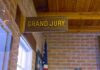 Jury Stalls After Explosive Cash Evidence Grand jury sign in a brick-walled hallway