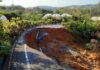 collapsed rural road with large sinkhole