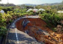 collapsed rural road with large sinkhole