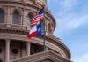 Ghost Payroll Hits Texas Texas and U.S. flags in front of a capitol building dome