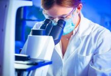 Air Pollution Linked to Alzheimer’s Risk Scientist using a microscope in a lab
