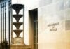 Cornell Panic: DOJ Heavyweight Called In Department of Justice building exterior with sign and metal sculpture
