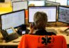 Queens 911 Confession Shocks Cops Emergency dispatcher at workstation with multiple monitors and phone