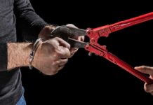 Outrage Erupts: Violent Offender Released Hands in handcuffs being cut with red bolt cutters