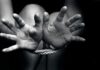 Hands bound with rope in black and white