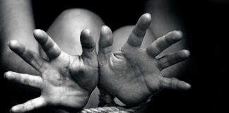 Hands bound with rope in black and white