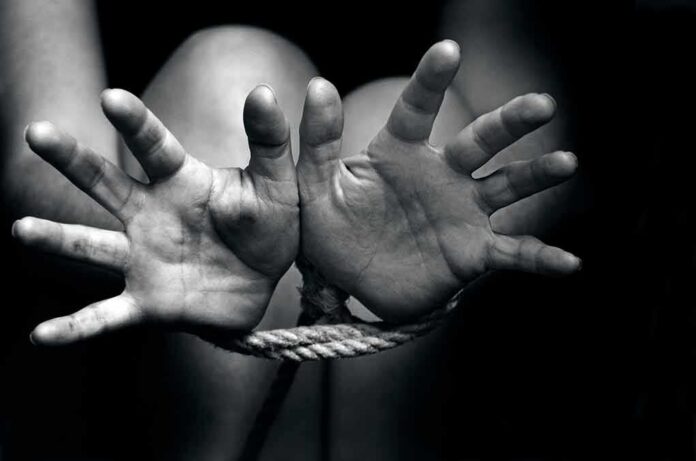 Hands bound with rope in black and white