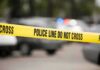 SUV Surge Turns Stroll Tragic Yellow police line tape at a blurred street scene