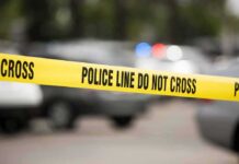 Four Teens Tagged In Child’s Killing Yellow police line tape at a blurred street scene