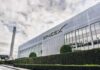 SpaceX For Every Kid – Or Just Hype? SpaceX headquarters exterior with rocket booster and hedge